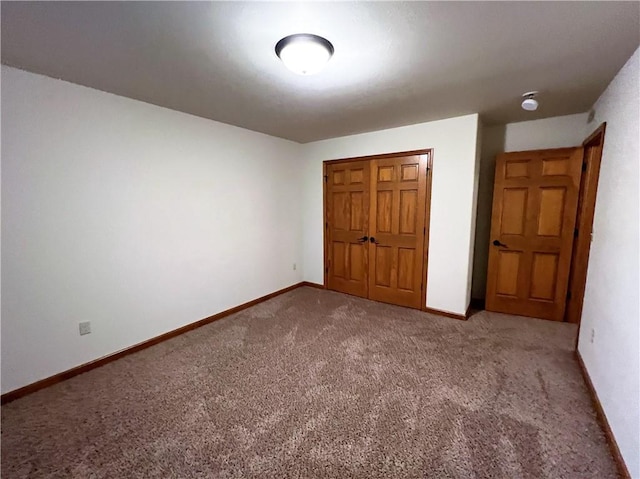 unfurnished bedroom featuring carpet floors and a closet