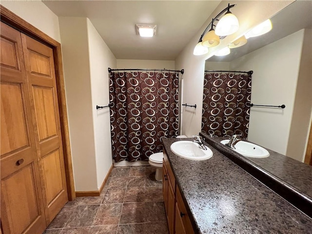 bathroom featuring vanity, tile patterned flooring, and toilet