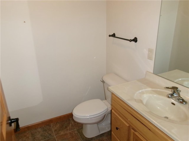 bathroom featuring vanity, toilet, and tile patterned flooring