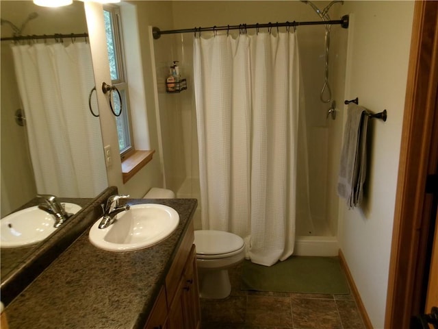 bathroom featuring toilet, tile patterned floors, and vanity