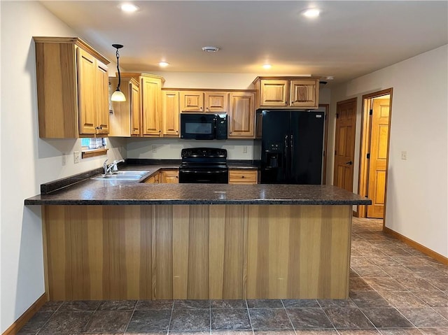 kitchen with dark tile patterned floors, kitchen peninsula, hanging light fixtures, black appliances, and sink