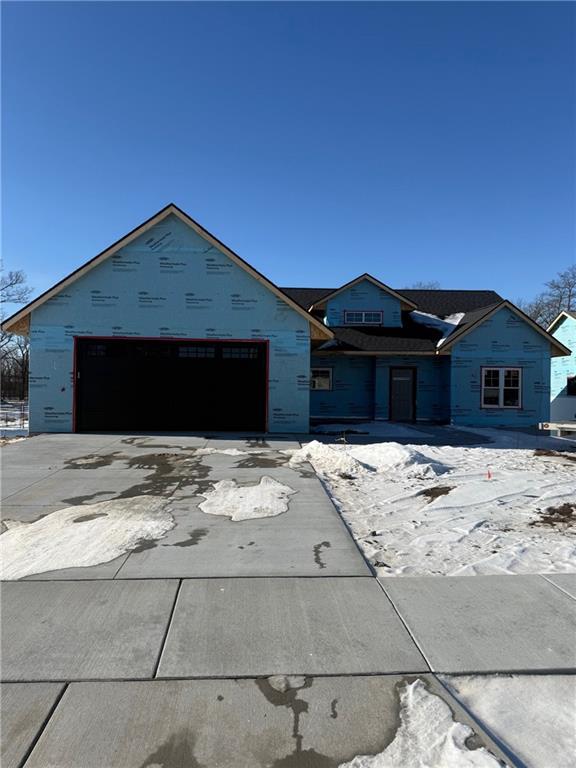 unfinished property with a garage and concrete driveway