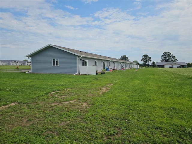 back of property with a lawn