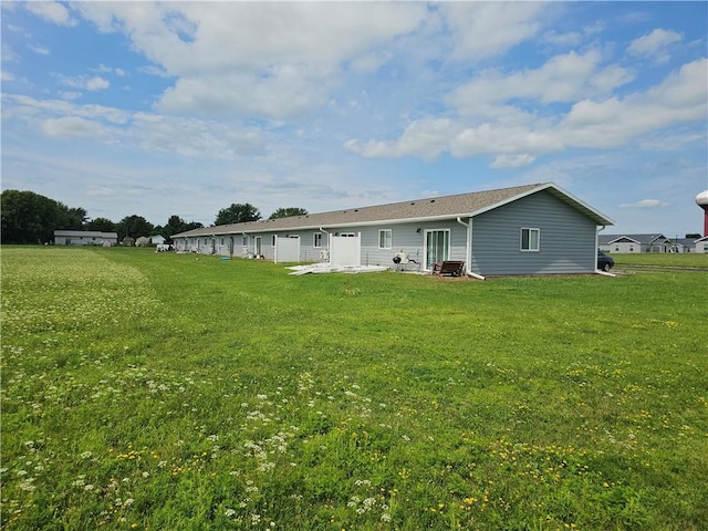 back of house with a yard and a patio area
