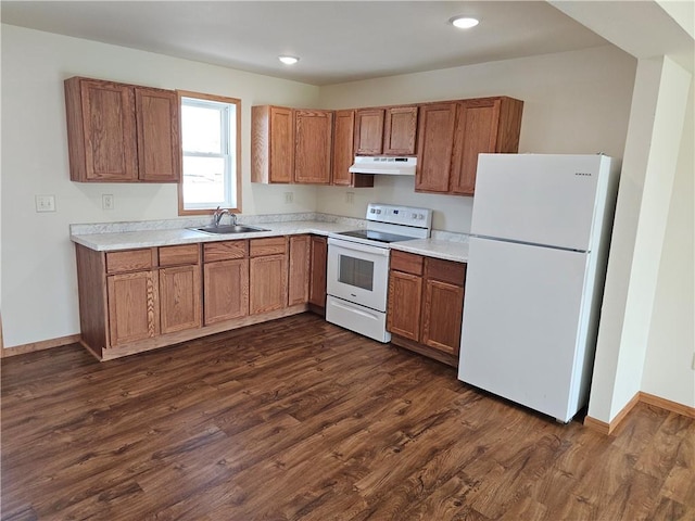kitchen with white appliances, dark hardwood / wood-style floors, and sink