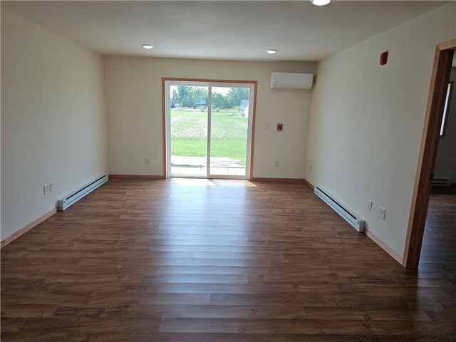 unfurnished room with dark hardwood / wood-style floors, a baseboard heating unit, and a wall unit AC