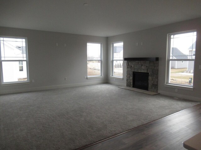 518 Woodside Ct, West Bend, WI 53095 - unfurnished living room featuring baseboards, wood finished floors, and a fireplace