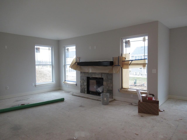 unfurnished living room with a stone fireplace