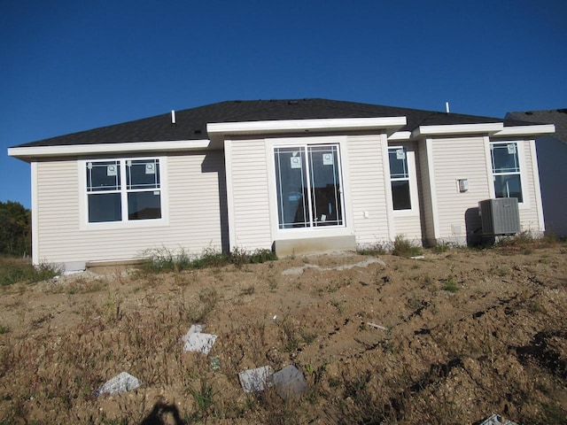 back of house with central AC unit