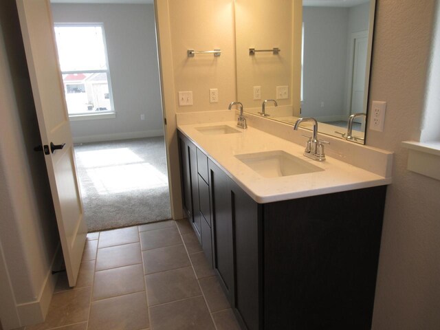 518 Woodside Ct, West Bend, WI 53095 - full bathroom with baseboards, tile patterned flooring, a sink, and double vanity