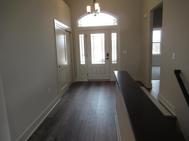 518 Woodside Ct, West Bend, WI 53095 - foyer featuring baseboards, dark wood-style floors, and a notable chandelier