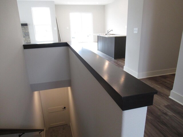 518 Woodside Ct, West Bend, WI 53095 - staircase with a wealth of natural light, wood finished floors, and baseboards