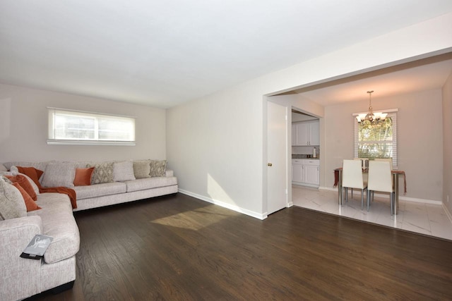 living room with a notable chandelier and wood-type flooring