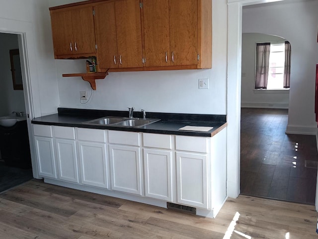 kitchen featuring light wood-type flooring and sink