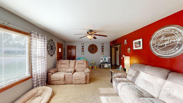 carpeted living room with ceiling fan