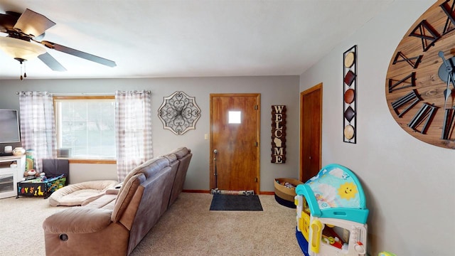 carpeted living room with ceiling fan