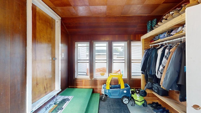 interior space featuring wood walls, lofted ceiling, and wood ceiling