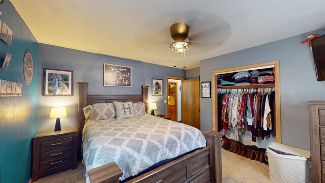 carpeted bedroom featuring a closet and ceiling fan