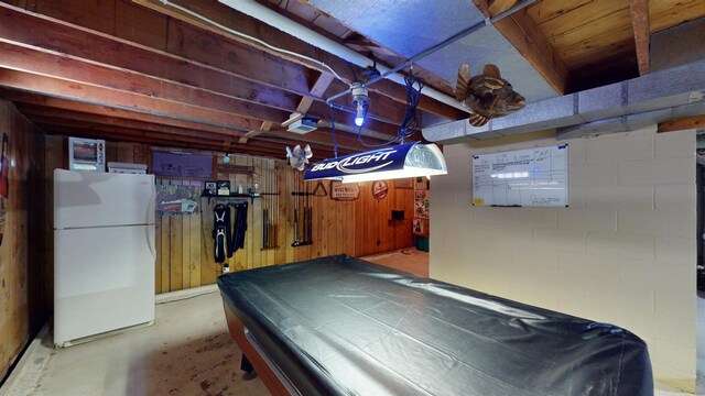 game room with wood walls and pool table