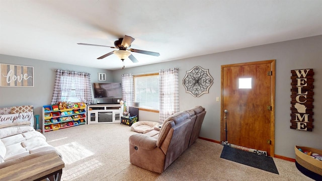 living room featuring ceiling fan, light colored carpet, and a wealth of natural light