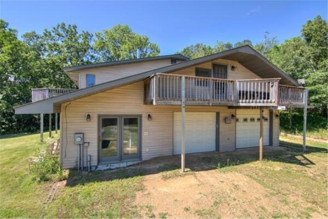 back of property featuring a yard and a garage