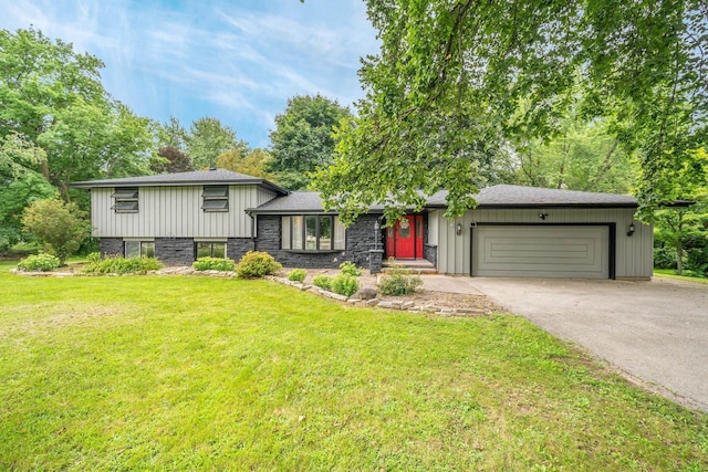 split level home with a garage and a front lawn