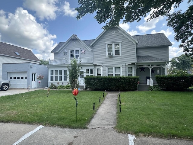 view of front of home featuring a balcony and a front yard