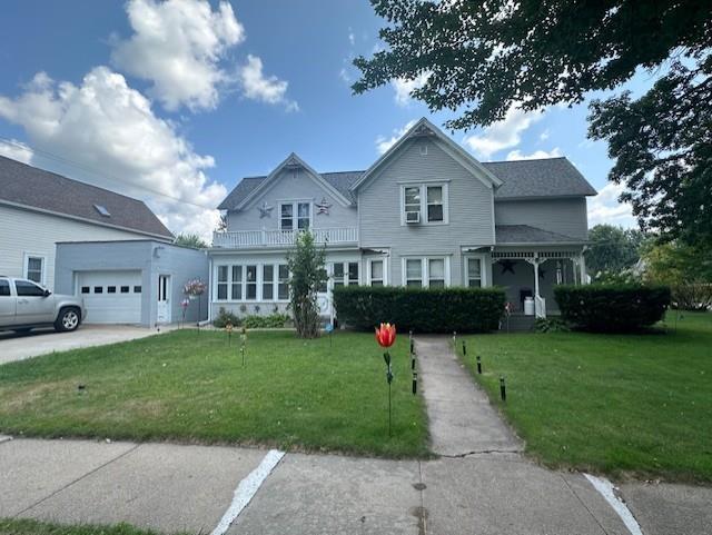 view of front of house with a garage and a front yard