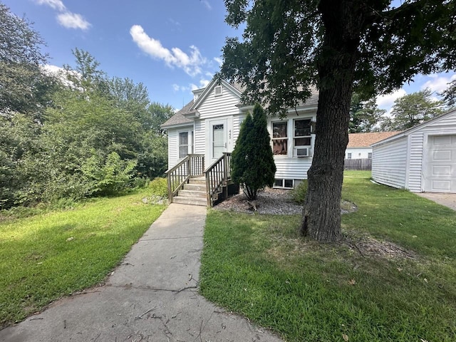 view of front of house with a garage, a front yard, and cooling unit