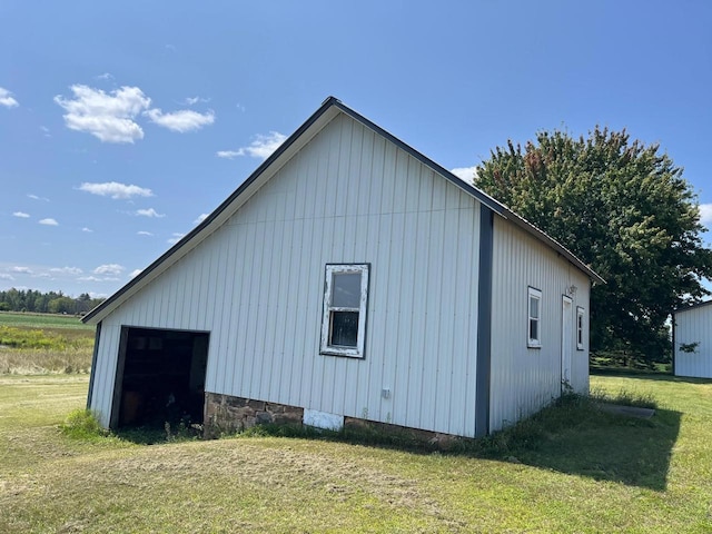 view of home's exterior with an outbuilding and a yard