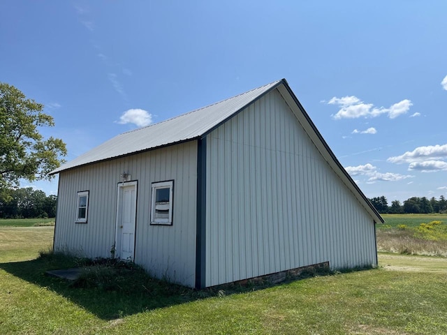 view of outbuilding featuring a lawn