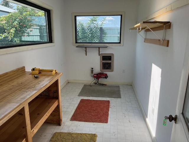 laundry area with light tile patterned flooring