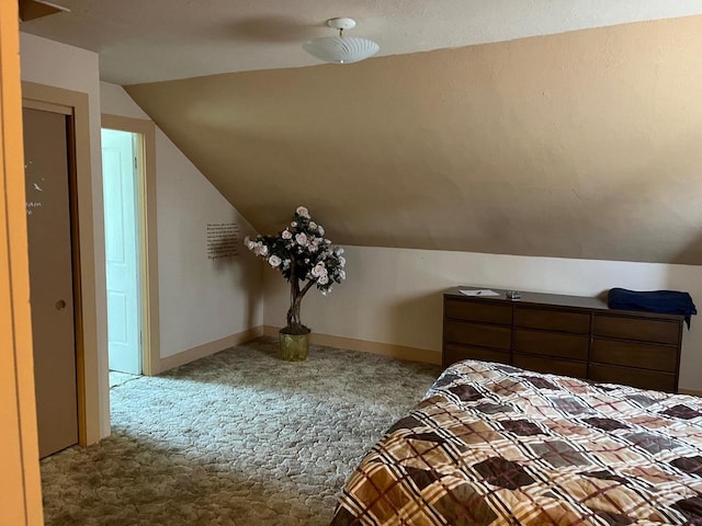 bedroom with lofted ceiling, a textured ceiling, light carpet, and ceiling fan