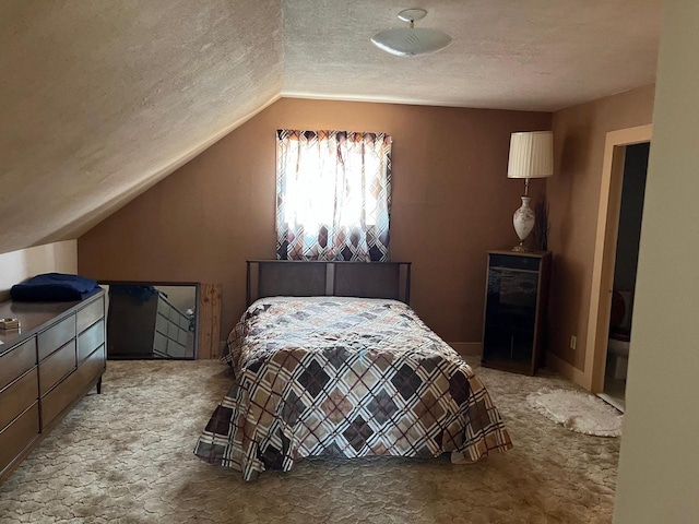 carpeted bedroom featuring a textured ceiling and vaulted ceiling