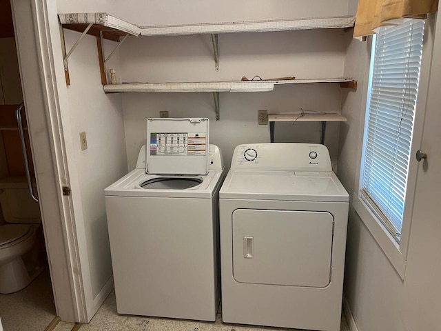 washroom featuring separate washer and dryer and a healthy amount of sunlight