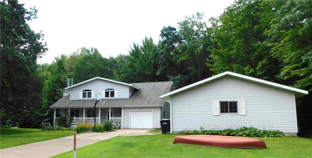 view of front facade with a garage, covered porch, and a front lawn