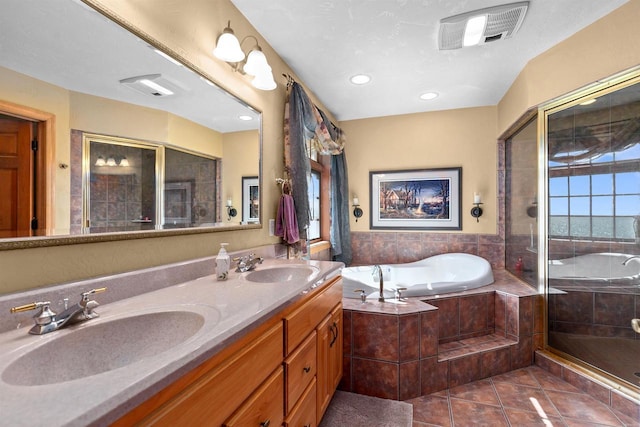 bathroom featuring tile patterned flooring, vanity, and separate shower and tub