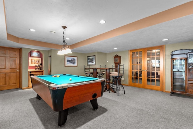 rec room with french doors, light colored carpet, billiards, and a textured ceiling