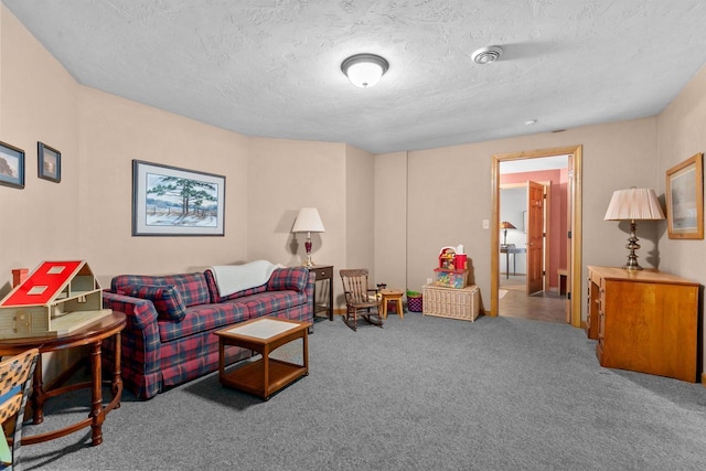 carpeted living room featuring a textured ceiling