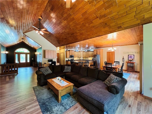 living room with lofted ceiling, wood ceiling, hardwood / wood-style flooring, and ceiling fan with notable chandelier