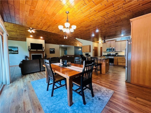 dining space featuring wood ceiling, ceiling fan with notable chandelier, and light hardwood / wood-style floors