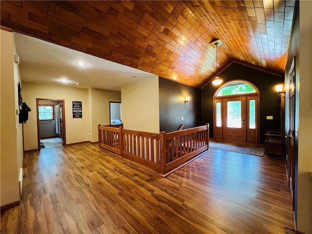 entryway featuring hardwood / wood-style floors and vaulted ceiling