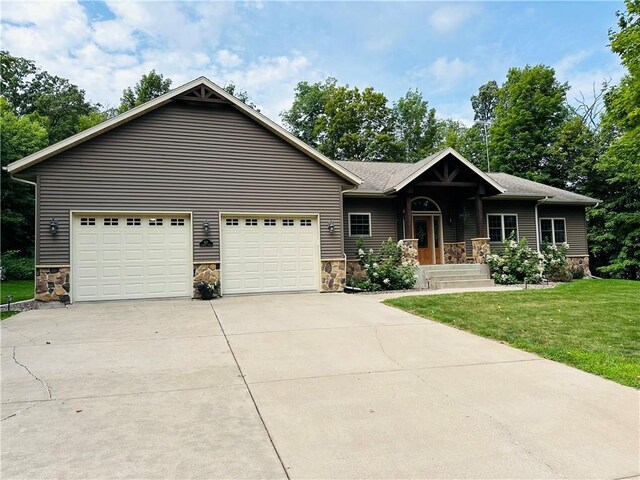 view of front of home featuring a front lawn and a garage