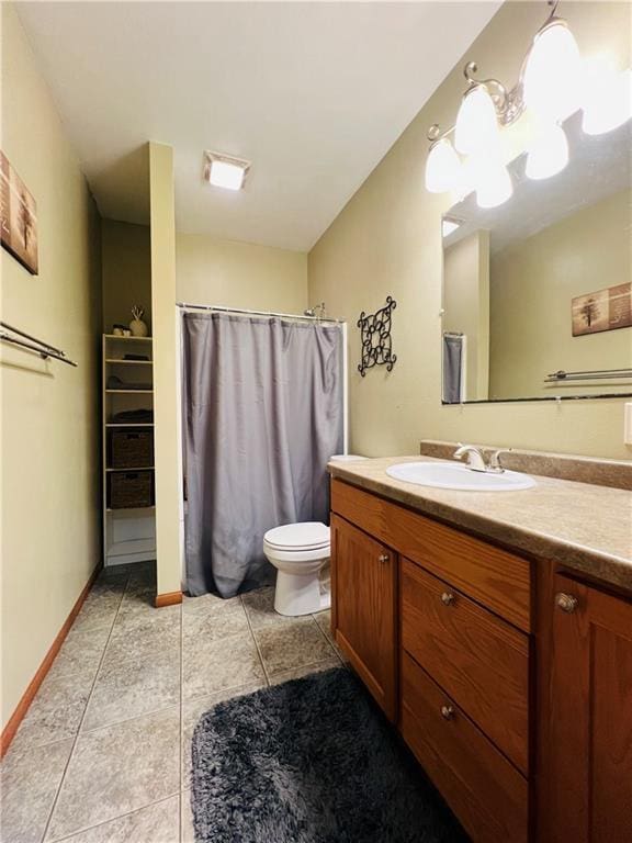 bathroom with vanity, tile patterned floors, and toilet