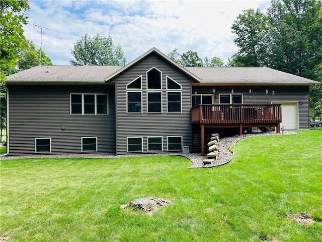 rear view of house featuring a wooden deck, a garage, and a lawn