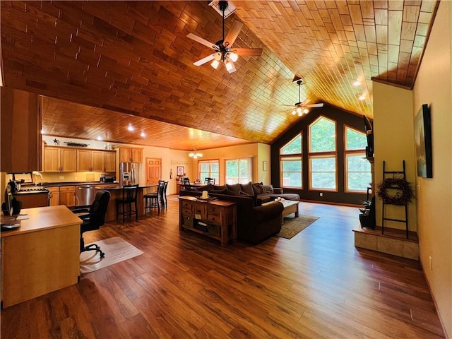 living room featuring dark wood-type flooring, brick ceiling, ceiling fan, and vaulted ceiling