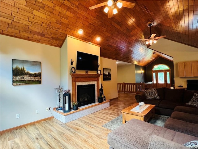 living room with vaulted ceiling, a fireplace, ceiling fan, light hardwood / wood-style floors, and wooden ceiling