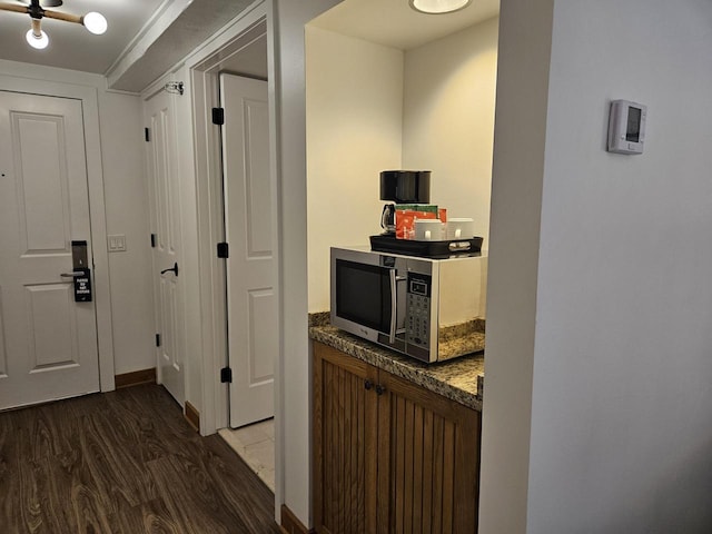 corridor with dark hardwood / wood-style floors