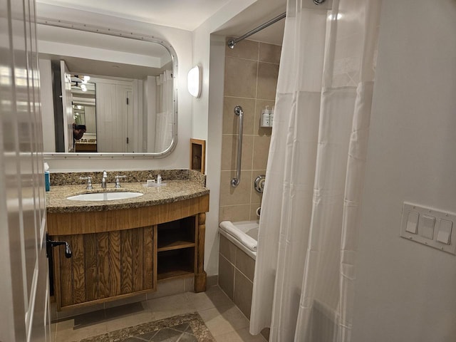 bathroom featuring tile patterned floors, shower / tub combo with curtain, and vanity