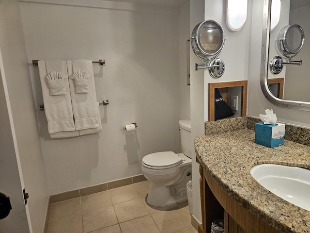 bathroom featuring toilet, tile patterned floors, and vanity